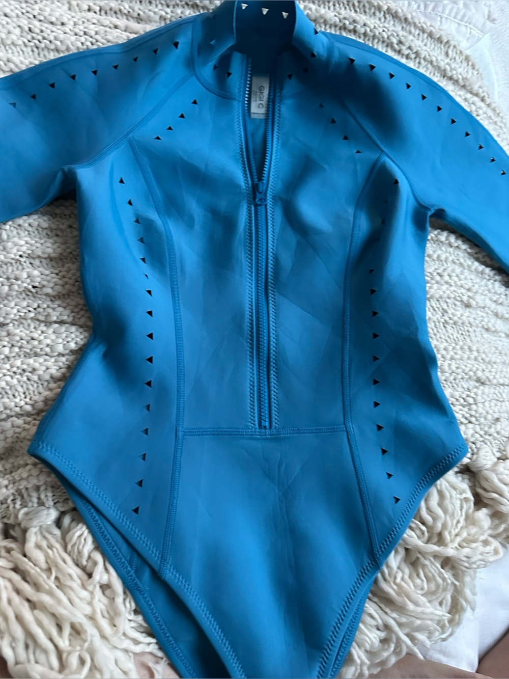 Gigi C women’s teal surf suit. Laser cut detail through out Never worn
